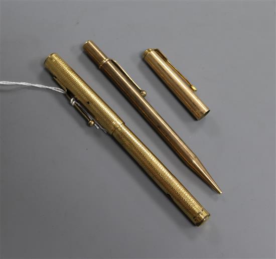Two gold plated pens and a lid